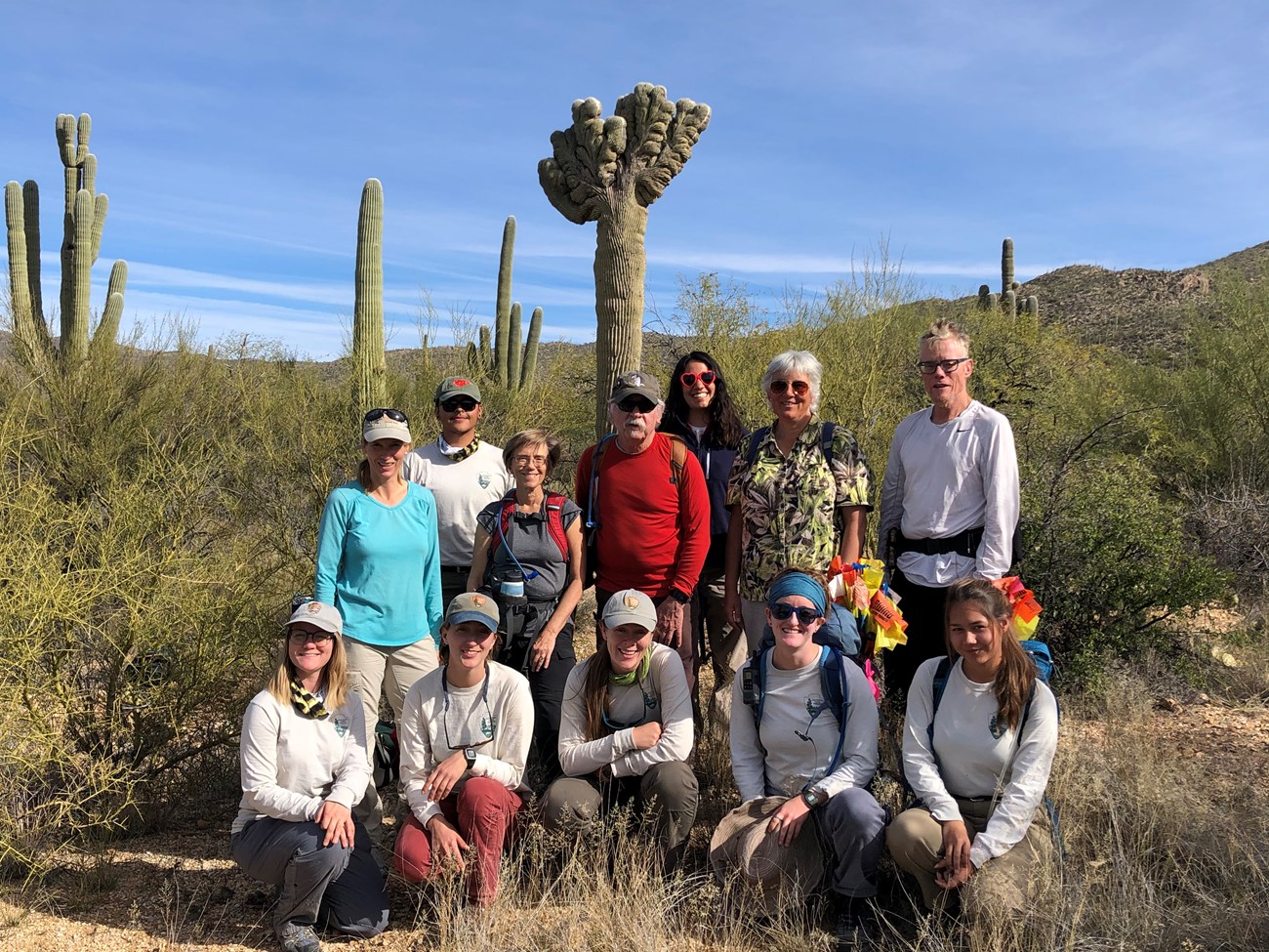 Group photo after the census. Behind them is a crested saguaro.