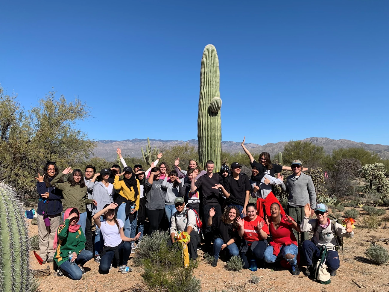 Arizona College Prep Academy Student volunteers and park staff posing like a saguaro.
