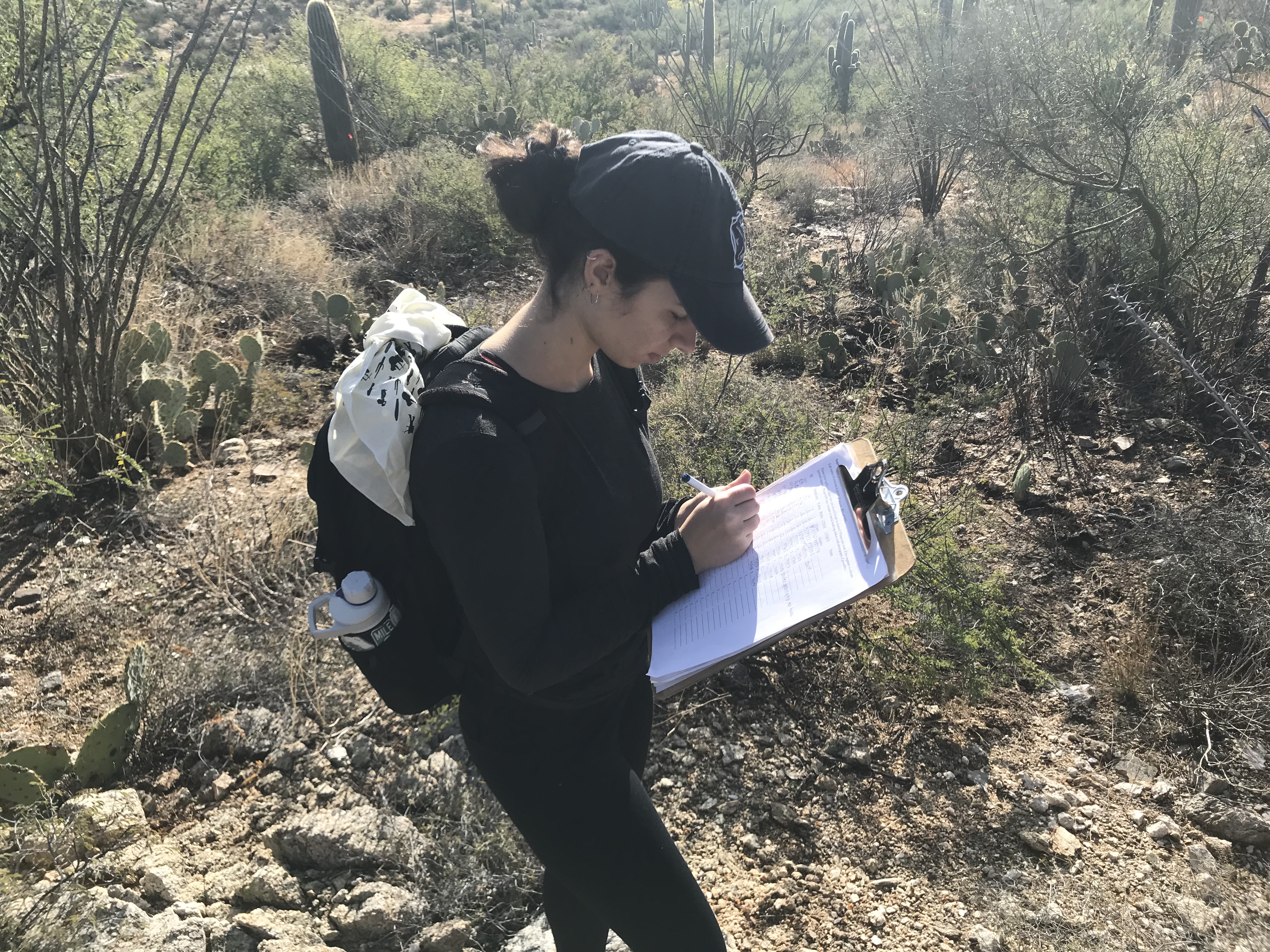 A woman writing down notes on a clipboard