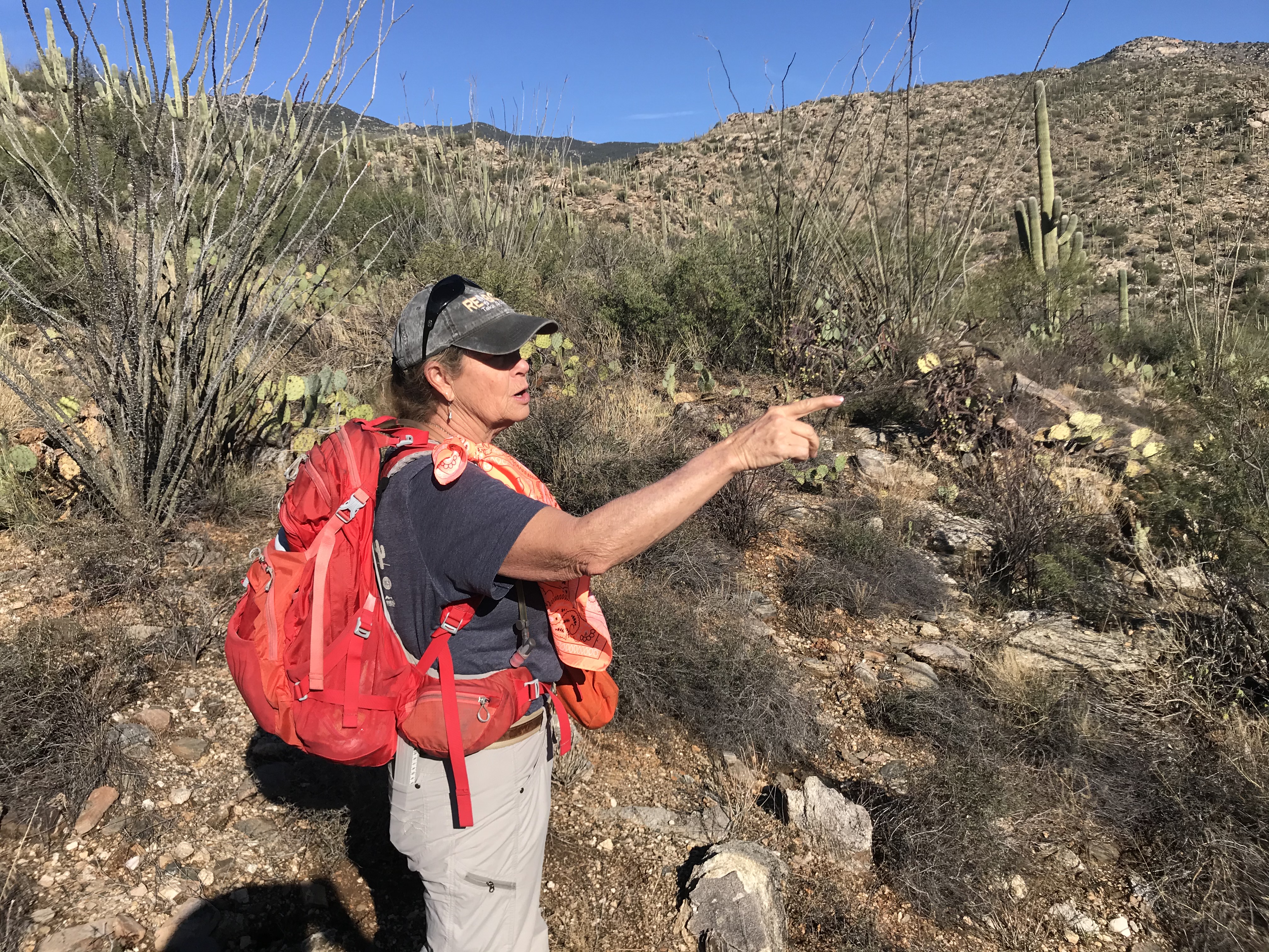 A woman with bright red pack pointing