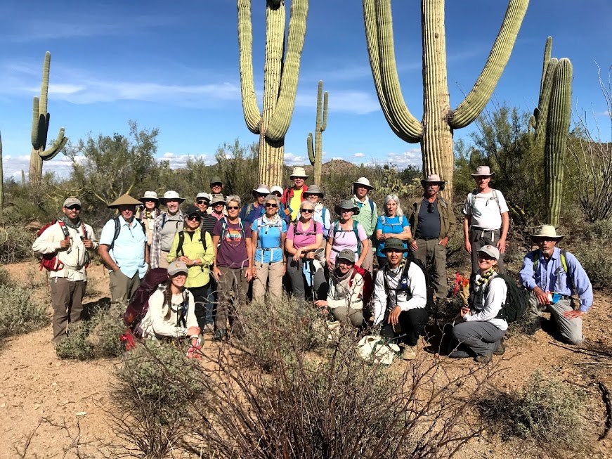 Group photo after the census. Behind them are saguaros and mountains.