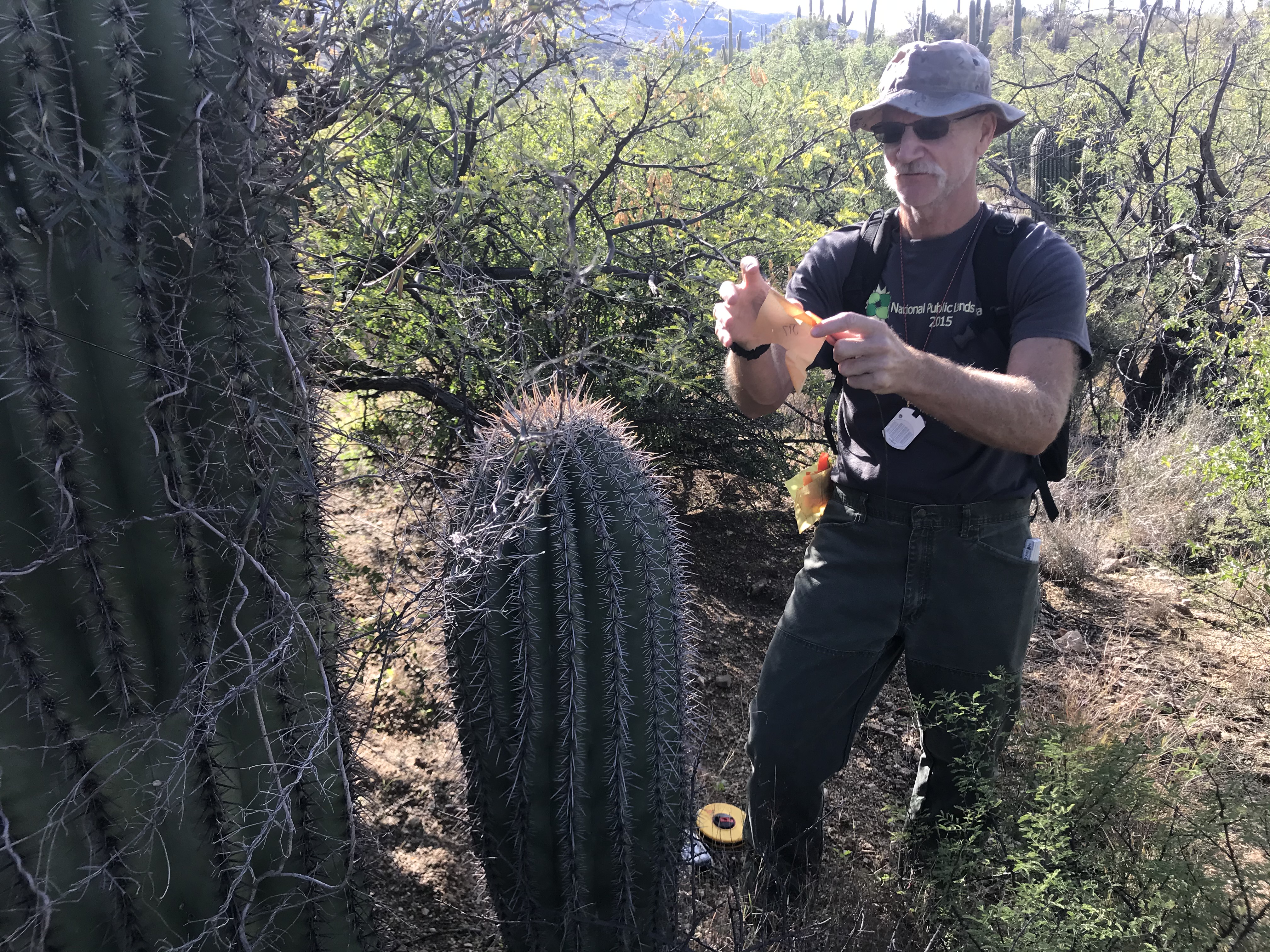 A man holding an orange flag