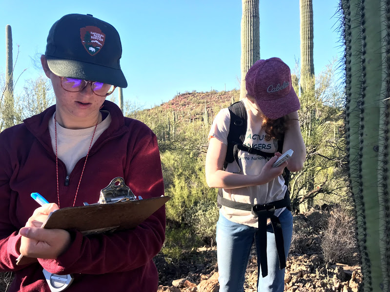 A girl writing notes on her clipboard.