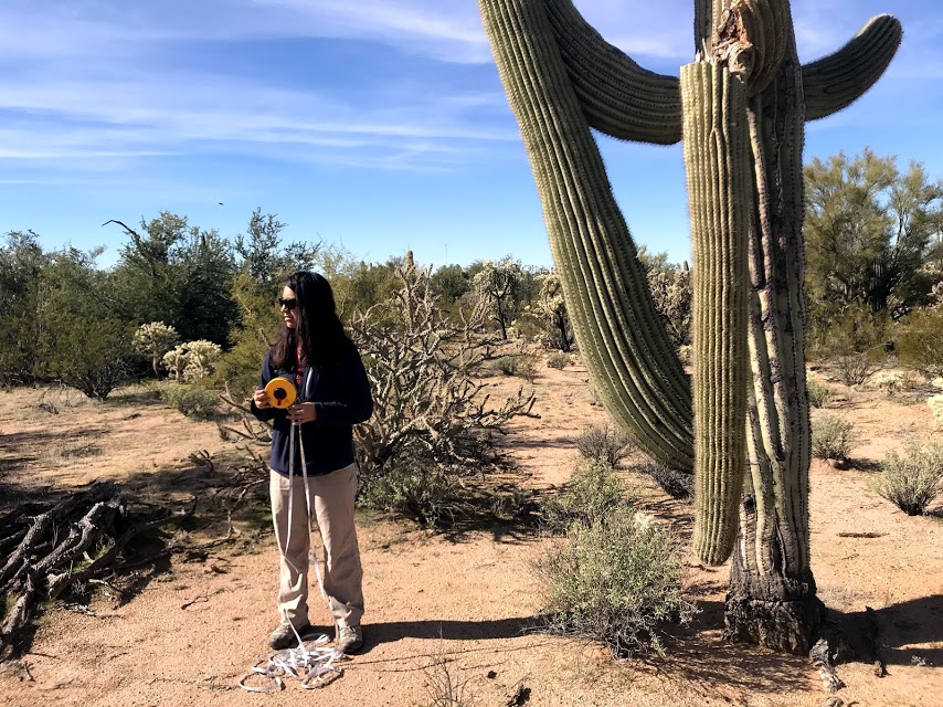 A woman holding a measuring tape.