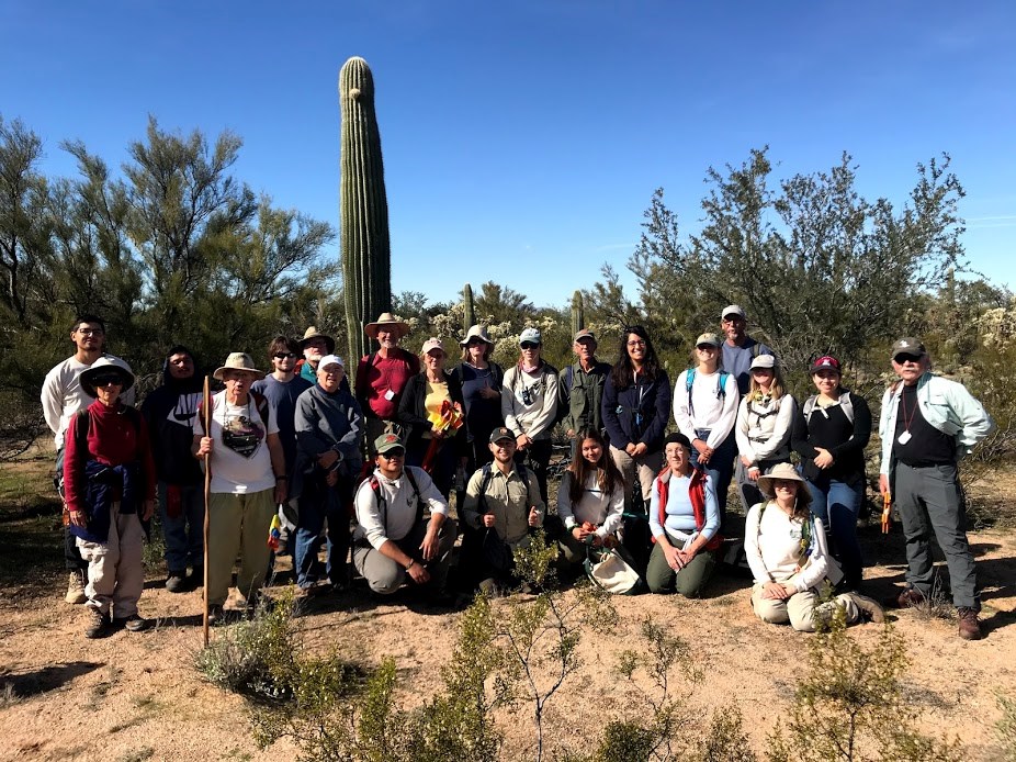 Group photo after the census. Behind them is a tall saguaro with a little nub on the front top of it.