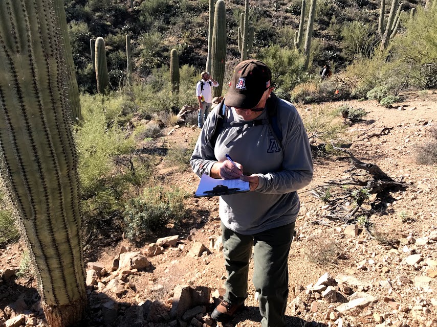 A person writing down data on a data sheet.