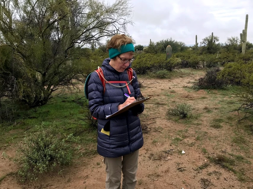 Writing down data A woman writing down data on her clipboard.
