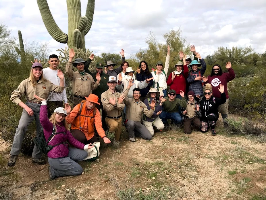 Individual volunteers and park staff Group of volunteers posing like a saguaro.