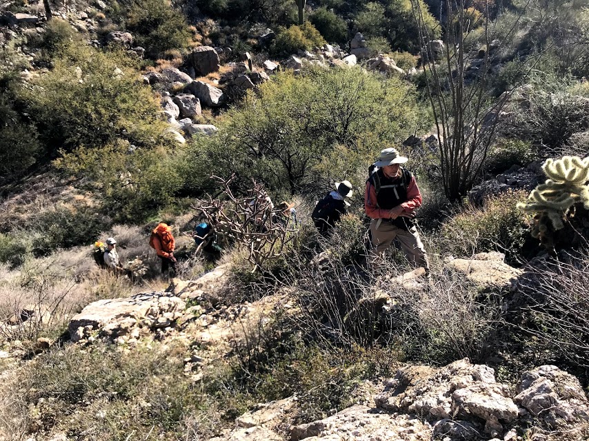 People hiking up to the plot.
