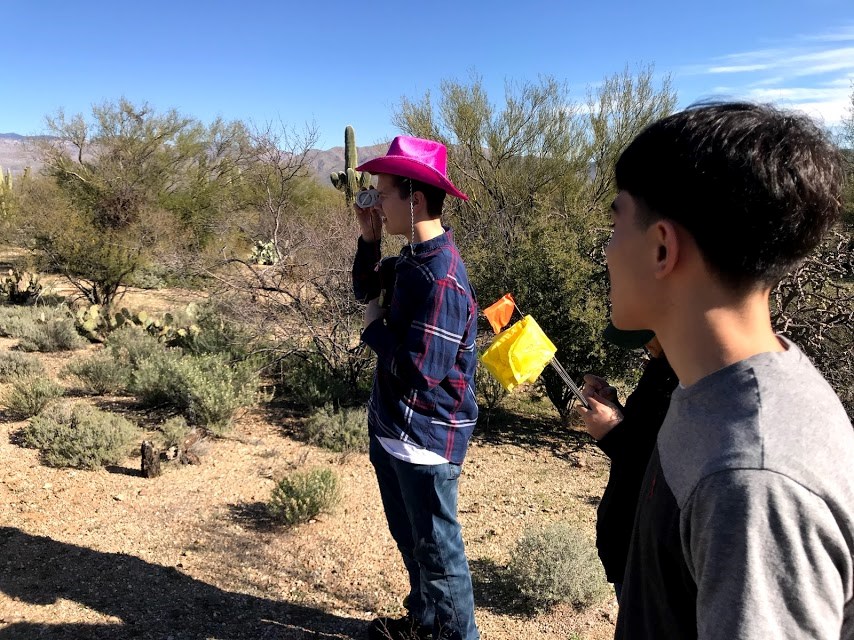 A student volunteer using a clinometer.