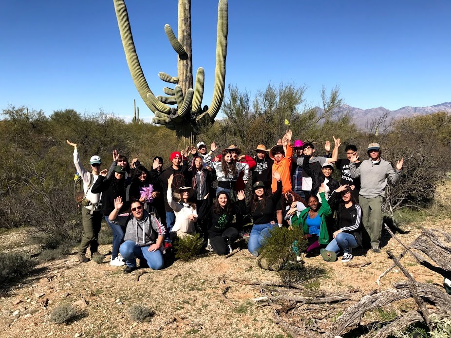 Students and park staff posing like a saguaro.