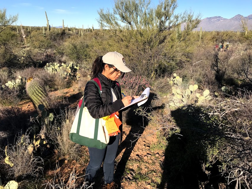 Park intern writing down data.