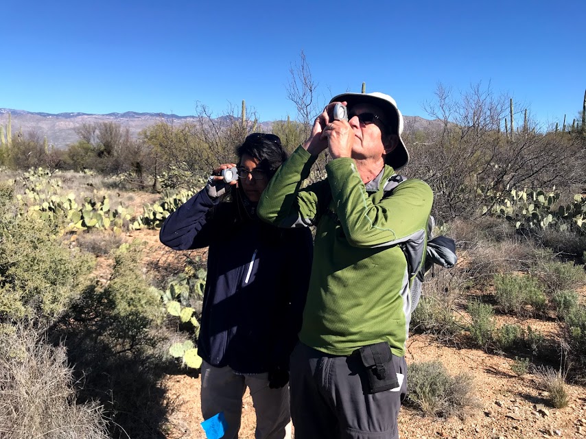 Volunteers using a clinometer.
