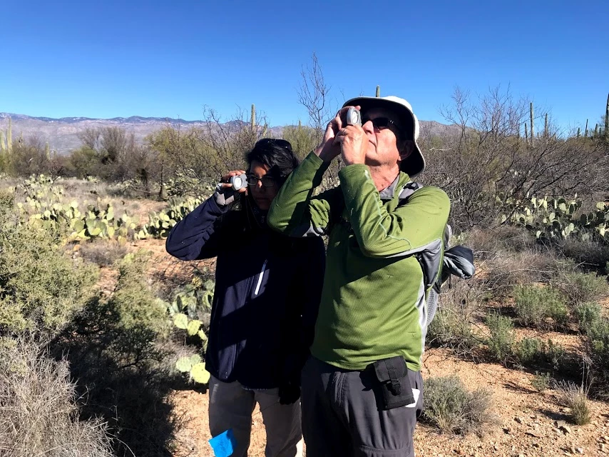 Volunteers using a clinometer Volunteers using a clinometer.