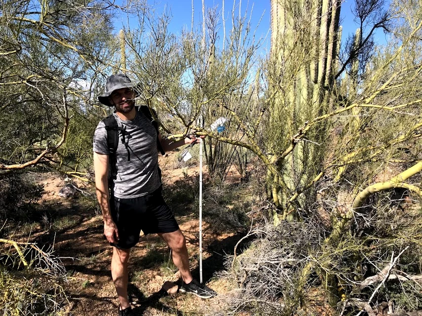 Volunteer smiles with meter stick Volunteer smiles with meter stick