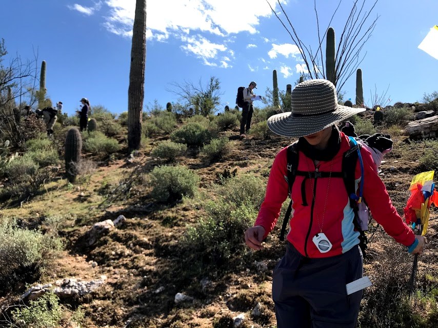 Volunteers navigate desert terrain