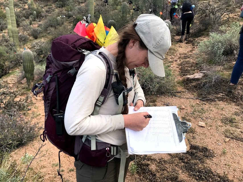 Park staff records saguaro census data on clipboard
