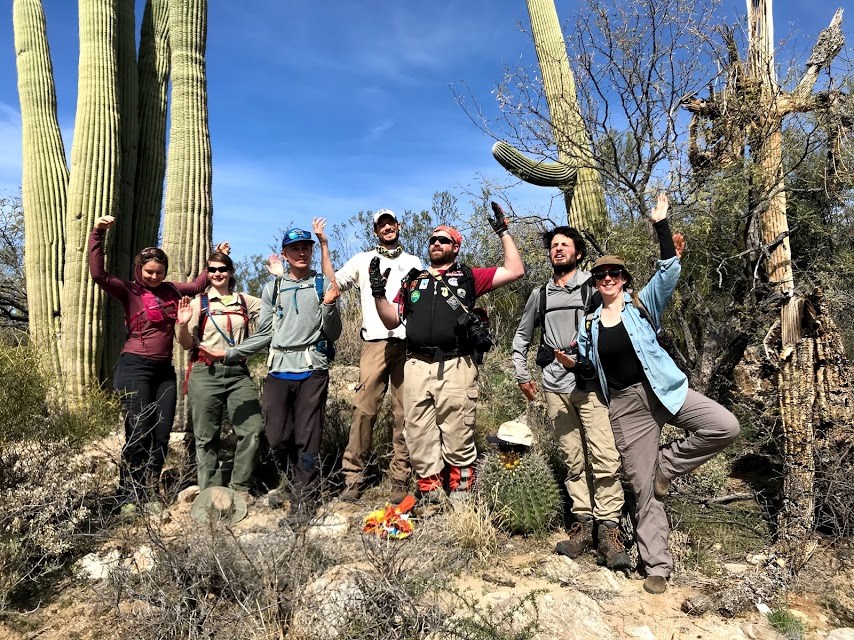 Volunteers posing like a saguaro.
