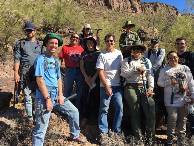 Invasive plants crew standing in front of mountain vista smiling.