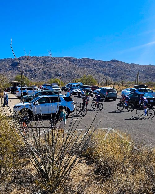 Looking East across the RMD parking lot on a normal fall through Spring day. Almost every spot full, line of cars fills the lot, and cyclists ride in and out of cars.