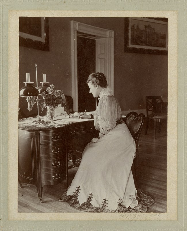 Photograph of Edith Roosevelt sitting at desk