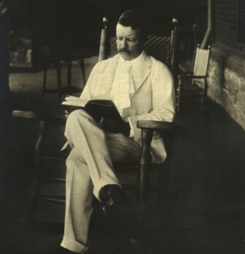 Theodore Roosevelt reading a book on his porch in 1904. Theodore Roosevelt reading a book on his porch in 1904.