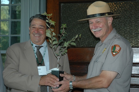 Greg Daniels of Bartlett Tree Experts presents a clone of the Cousins' Beech to Charles Markis of the NPS.