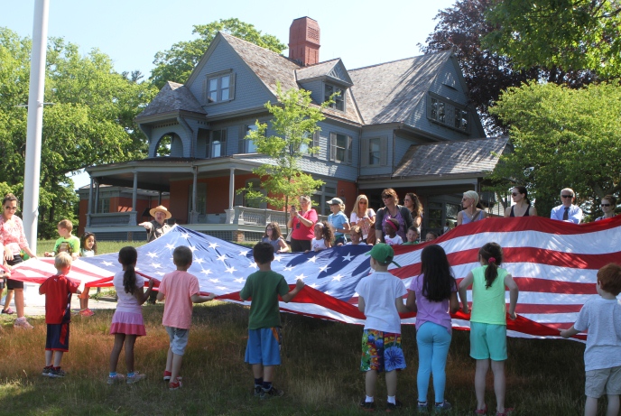 Fourth grade students practice U.S. flag etiquette with the help of National Park Service Rangers at Sagamore Hill National Historic Site in New York. Sagamore Hill, at Oyster Bay, was the home of Theodore Roosevelt and his family. National Park Service Photo