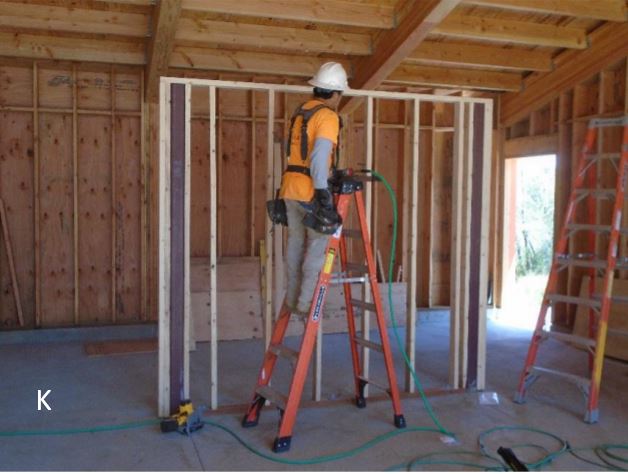 Building freestanding exhibit wall Worker building freestanding exhibit wall