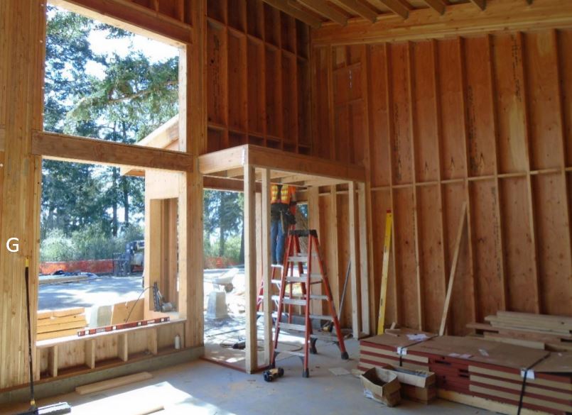 Interior vestibule framing Worker framing vestibule from inside of building