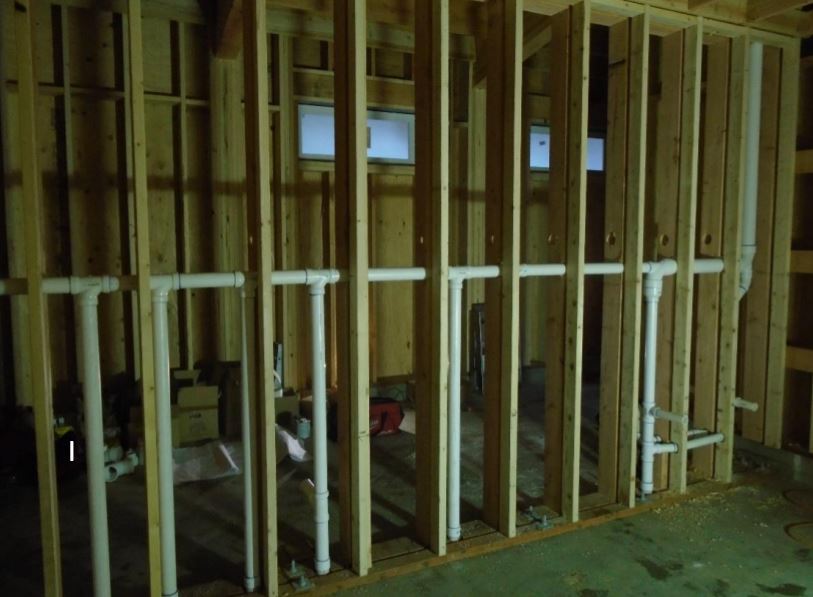 Rough-in plumbing for restrooms Roughed-in plumbing for restroom inside framing