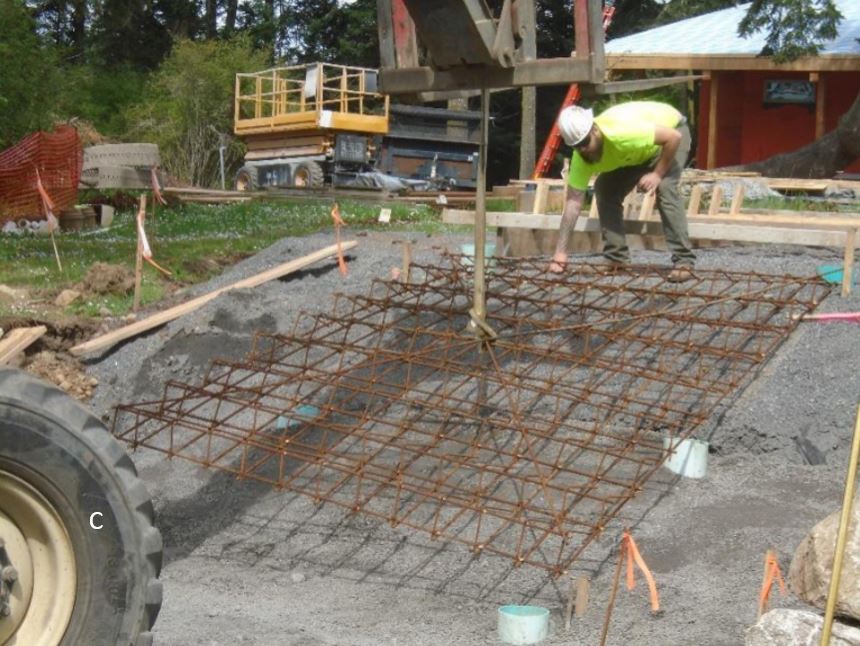 Rebar installation for parking lot steps Meshed rebar being lowered into place to accept concrete steps