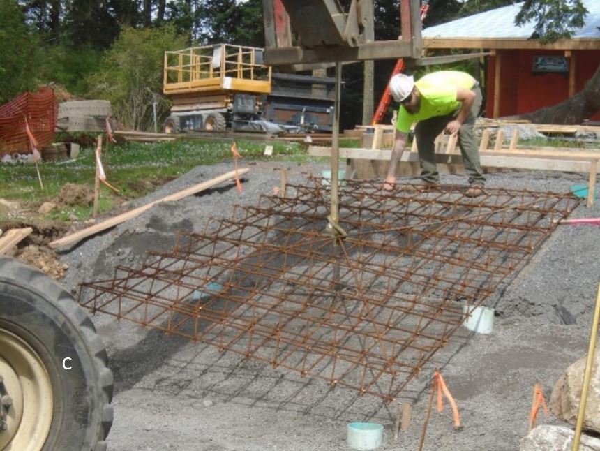 Meshed rebar being lowered into place to accept concrete steps