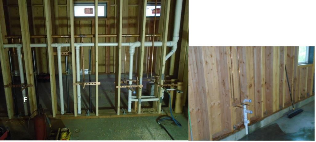 View of plumbing infrastructure in place between framed walls