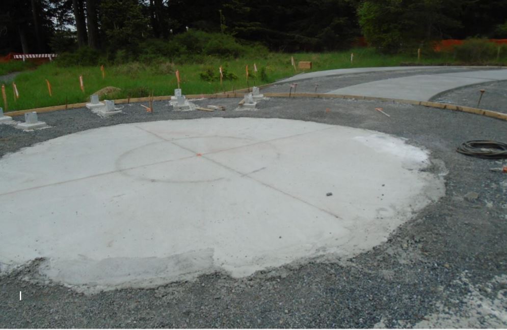 Round concrete pad being readied for bronze pig Cured concrete pad for bronze pig being completed