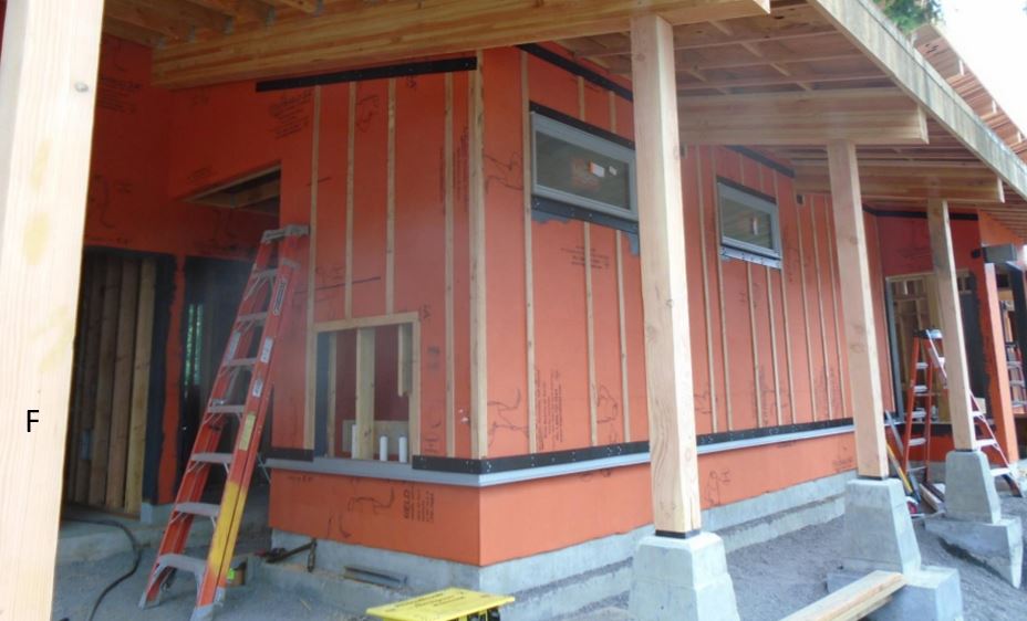 Front of building showing waterproof barrier, window waterproofing, and rain shield