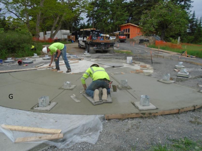 Interpretive plaza concrete finishing Concrete finishing work on interpretive plaza proceeds