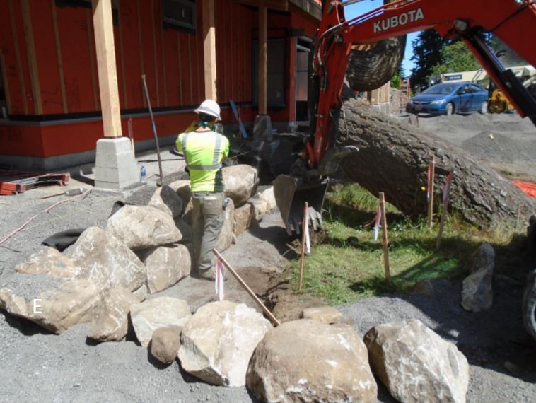 Bolder retaining wall front of building Granite boulder wall in front of building