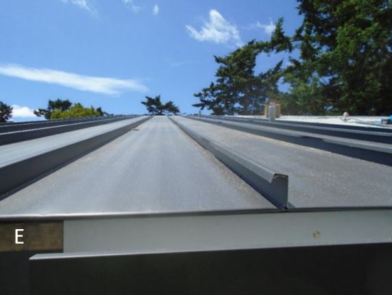 View of standing seam roofing panels being installed