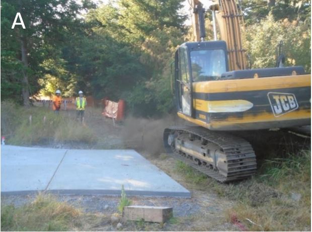 Backhoe clearing access to the redoubt access road