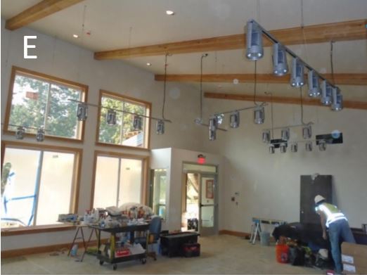 Workers installing hanging light fixtures