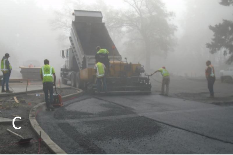 Laying asphalt in the fog Workers putting down asphalt in front of visitor center