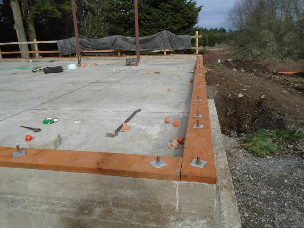 Wood boards are installed on the top of the foundation exterior walls and on the slab floor for the interior walls