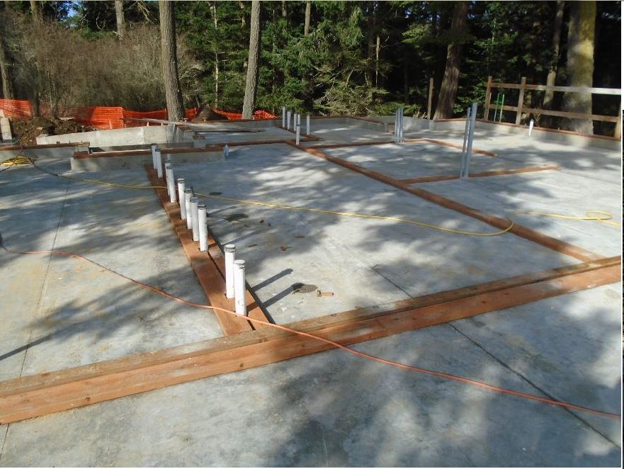 Wood boards are installed on the top of the foundation exterior walls and on the slab floor for the interior walls