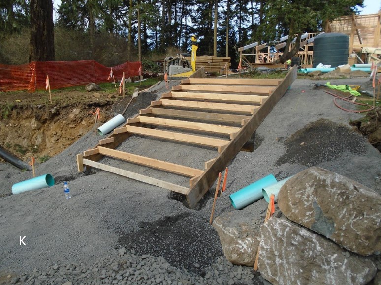 Concrete steps from lower parking area to upper parking area are formed and ready for concrete