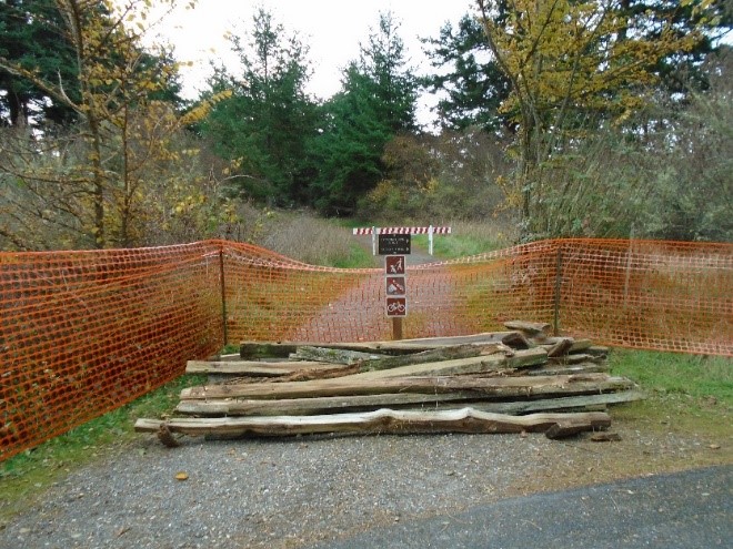 Pile of split rail fence is staged away from the work site for later re-purposing