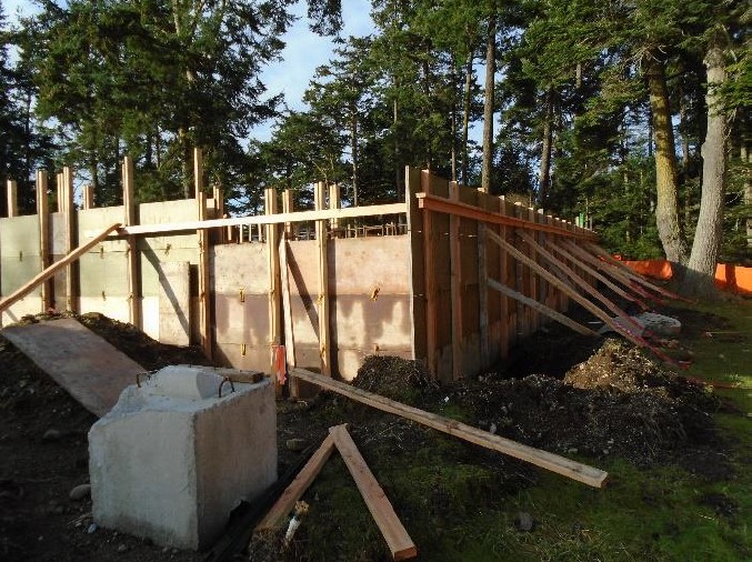 Wood boards and panels create a frame for the building foundation.