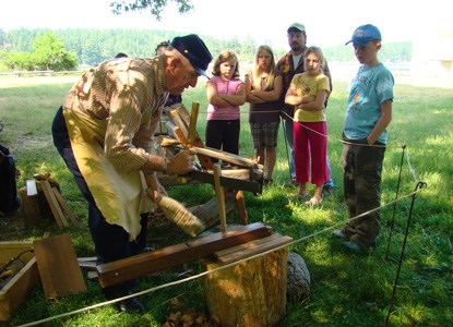 Gordon Smith demonstrates wood working tools for visitors.