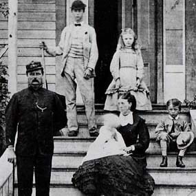 Capt. William Addis Delacombe and his family on the front steps of their house at the Royal Marine Camp.