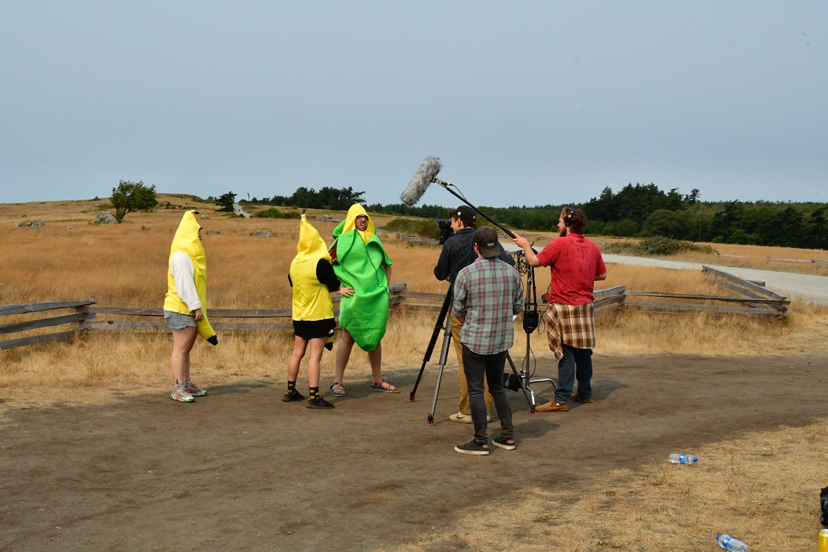 Pictures of people in fruit costumes filming a movie